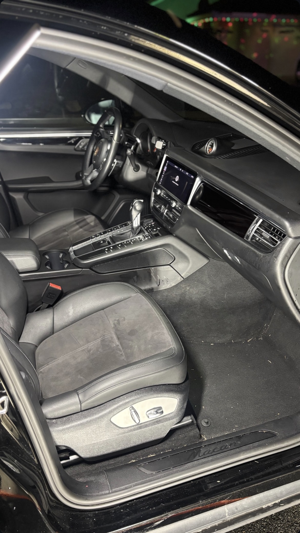 Porsche Macan interior before detailing — dirty carpet and dusty seats