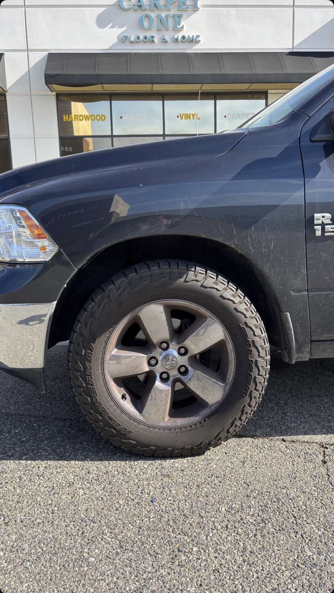RAM 1500 wheel before detailing — oxidized and road-dirty